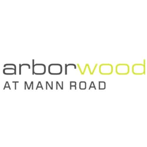 Logo with the words "arborwood" in gray and green text, and "AT MANN ROAD" in gray uppercase letters below, representing one of the welcoming Apartment Communities in Indianapolis.